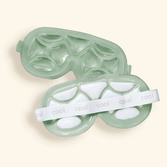 Green eye mask with white cooling gel pads on a beige background